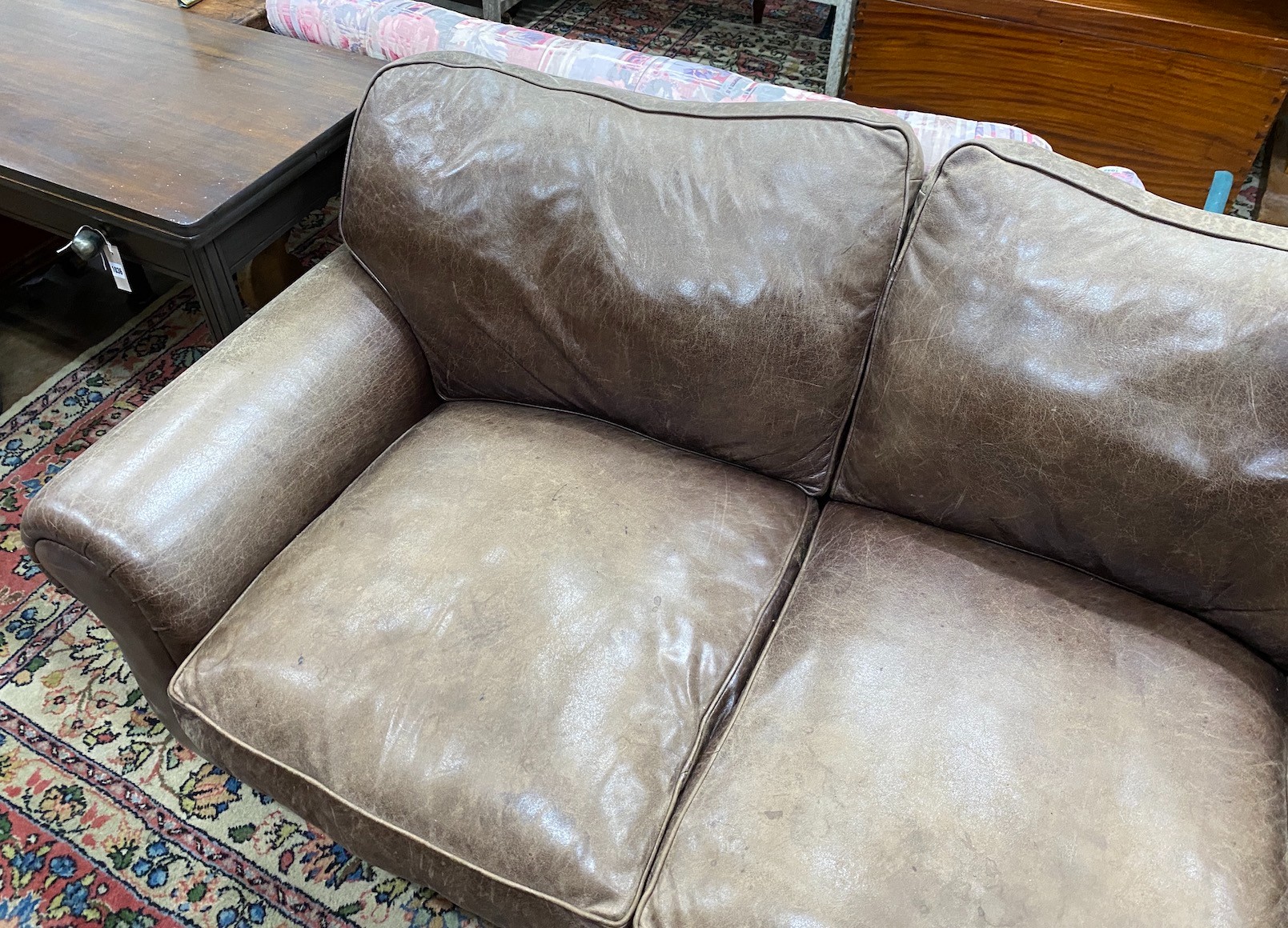 A Laura Ashley brown leather upholstered two seater settee, width 172cm